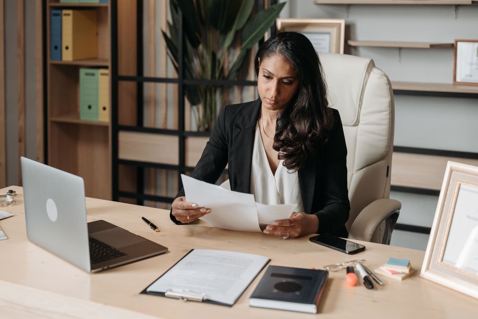 A businesswoman at her desk, deep in a busy workday
