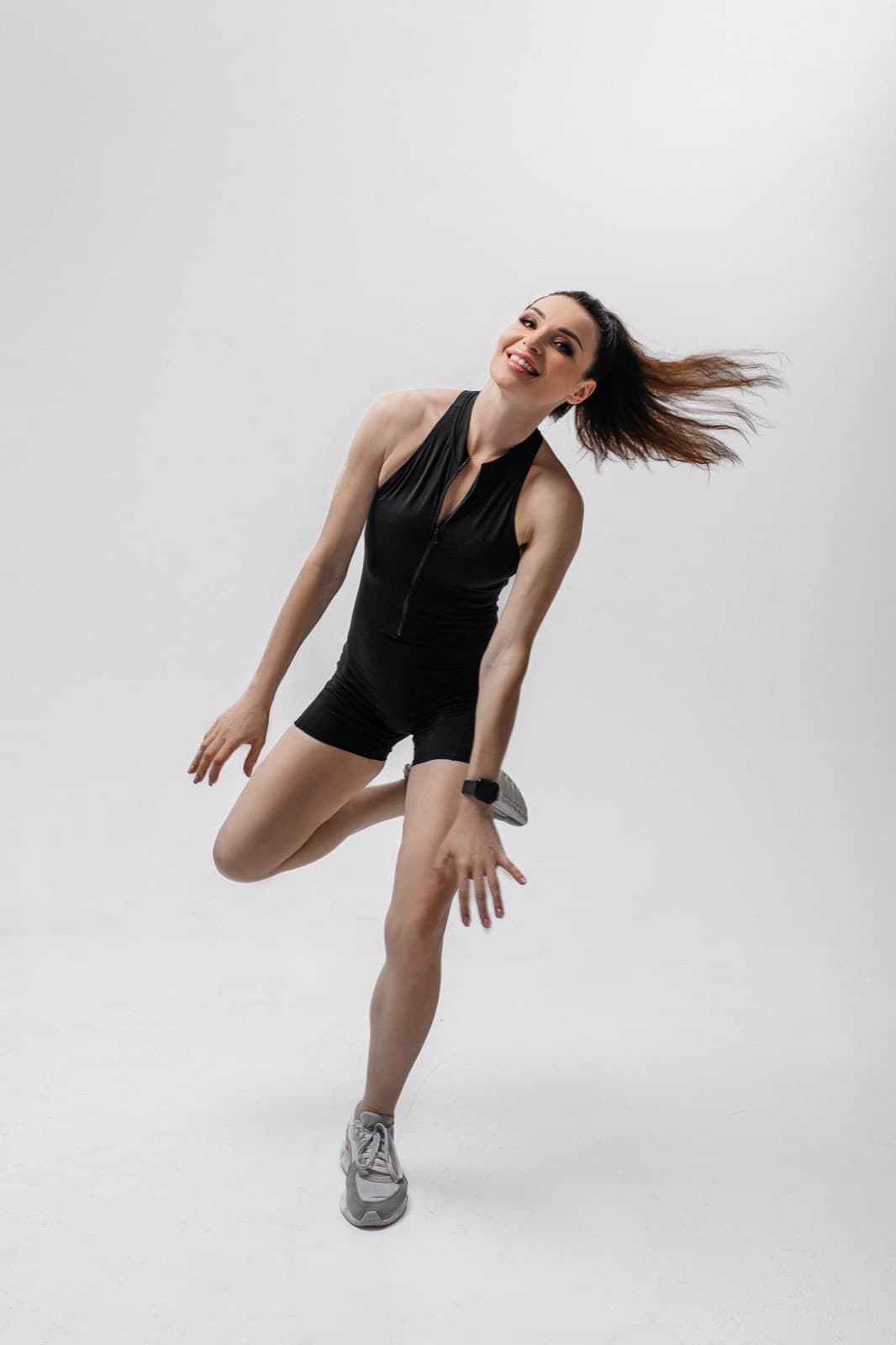 Anastasiia, the Lean Sporty instructor, mid-jump in a dance workout